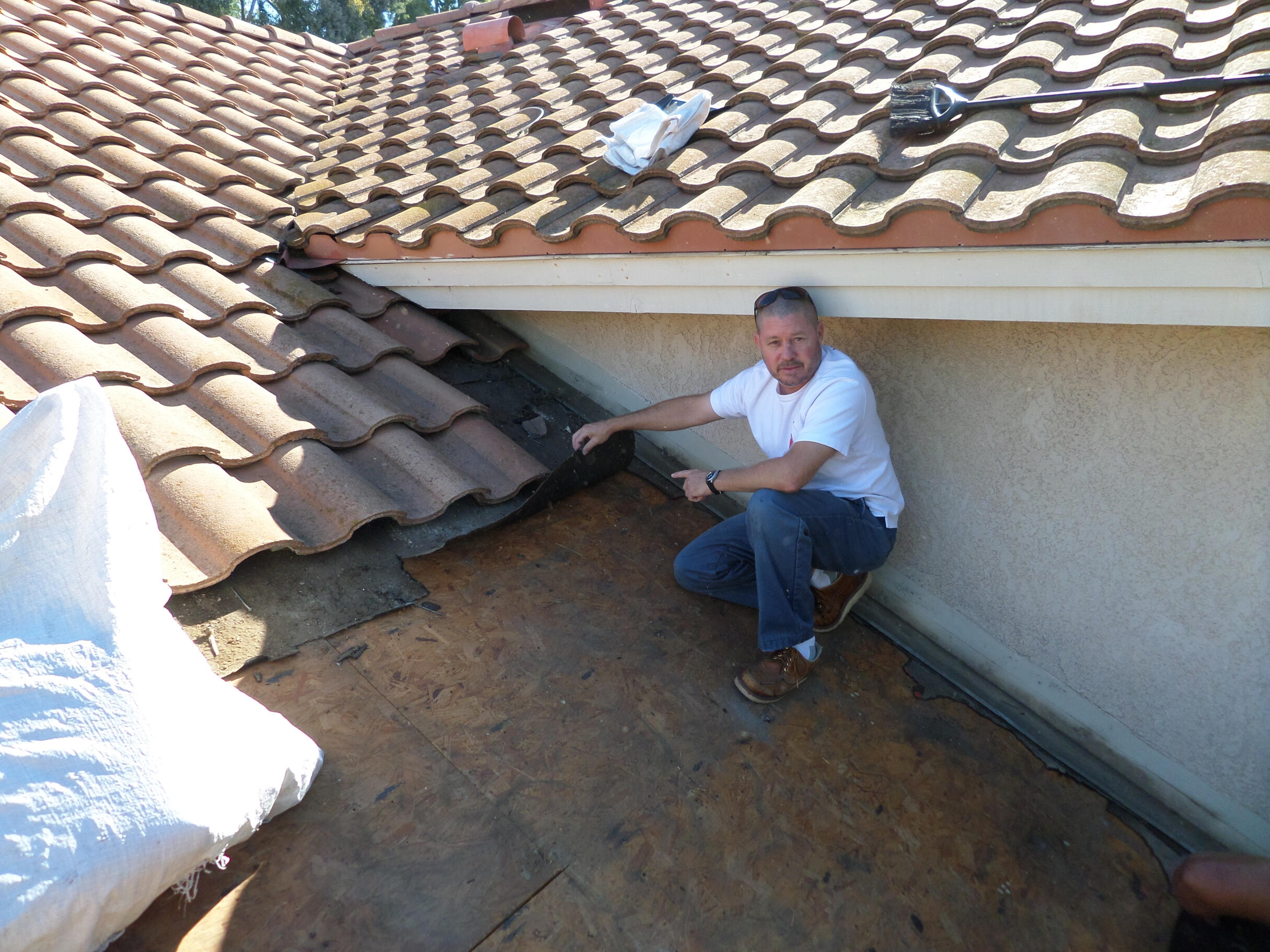 tile roof leak repair and inspection roofers fixing a roof leak